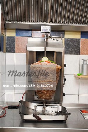 Döner kebab on spit in the kitchen of a snack bar