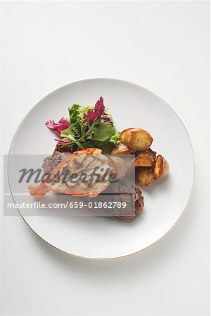 Surf and Turf (beef steak and prawn) with fried potatoes Surf and Turf (beef steak and prawn) with fried potatoes