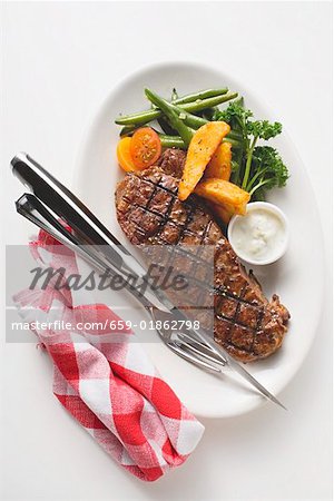 Grilled beef steak with vegetables and dip