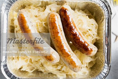 Sausages with sauerkraut in aluminium container to take away