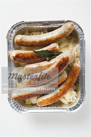 Sausages with sauerkraut in aluminium container to take away