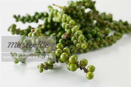 Clusters of green peppercorns