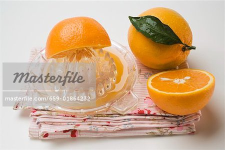 Oranges with citrus squeezer Oranges with citrus squeezer