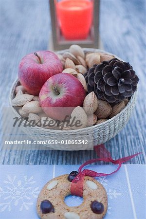 Christmas decoration with apples, nuts, candle & gingerbread