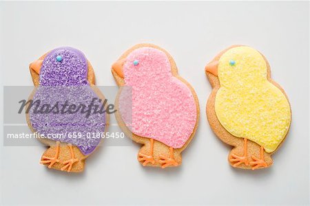 Three Easter biscuits (purple, pink, yellow chicks)