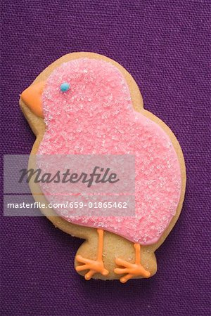 Easter biscuit (pink chick) on purple linen