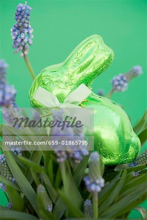 Green Easter Bunny among spring flowers Green Easter Bunny among spring flowers