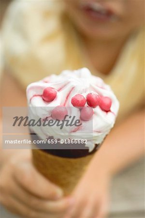 Child holding ice cream cone