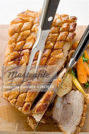 Roast belly pork with crackling and vegetables