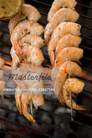 Prawn kebabs on barbecue grill rack