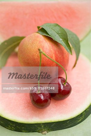 Nectarine with leaves, watermelon and cherries