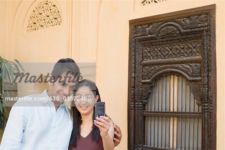 Young couple taking a photograph of themselves with a mobile phone