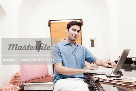 Portrait of a young man using a laptop