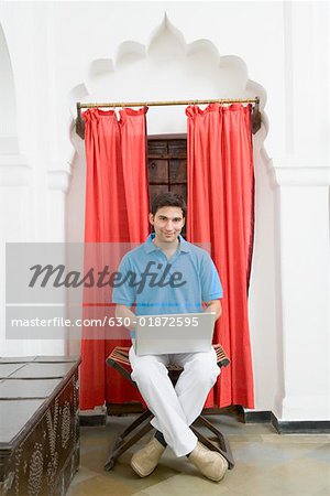 Portrait of a young man using a laptop