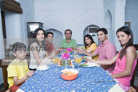 Portrait of a group of people sitting at a dining table