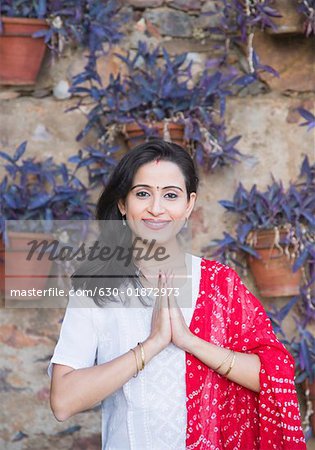 Portrait of a mid adult woman standing in a prayer position