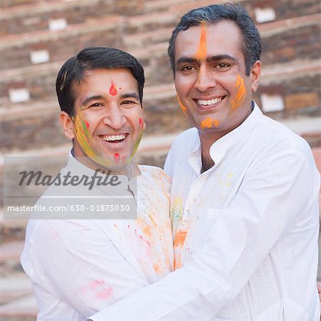 Portrait of two mid adult men hugging each other