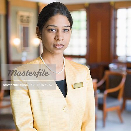 Portrait of a waitress standing in a lobby