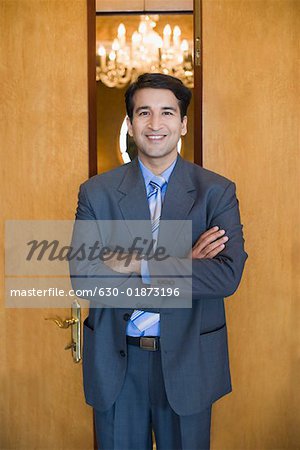 Portrait of a businessman standing with his arms crossed and smiling
