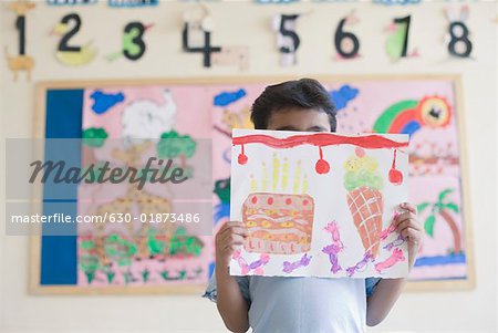 Schoolboy showing a painting