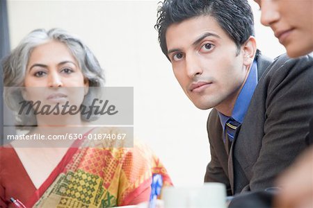 Two businesswomen and a businessman in a conference room