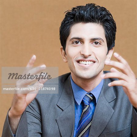 Portrait of a businessman gesturing and smiling