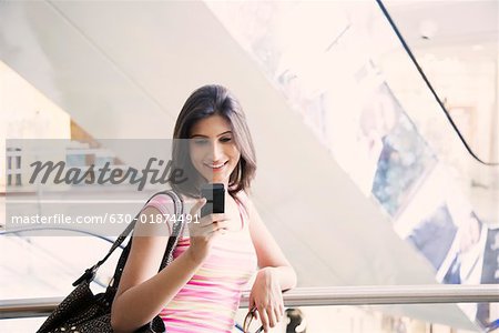 Young woman using a mobile phone and smiling