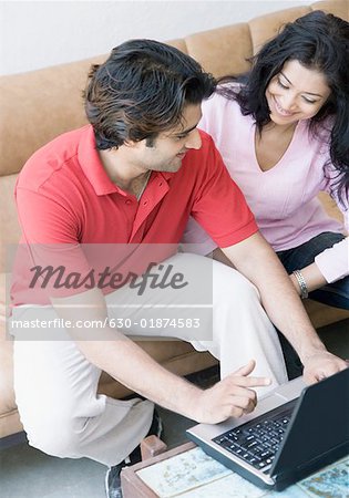 High angle view of a young couple using a laptop