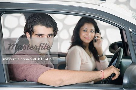 Close-up of a young couple sitting in a car