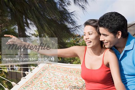 Close-up of a young couple sitting in a hammock