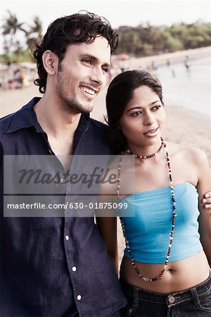 Close-up of a young couple standing on the beach