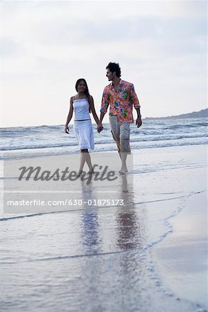 Young couple walking on the beach