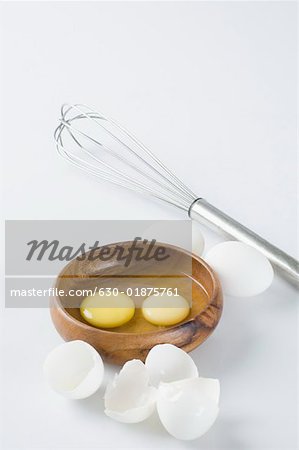 Close-up of egg yolks in a wooden bowl