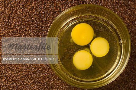 Close-up of egg yolks in a glass bowl