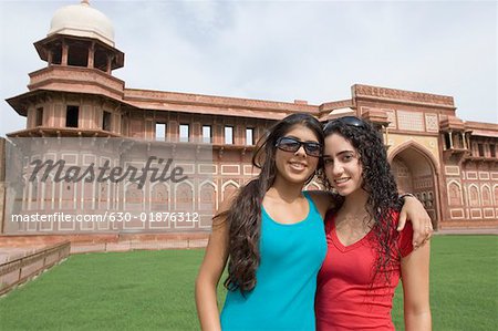 Portrait of two young women standing together and smiling, Taj Mahal, Agra, Uttar Pradesh, India