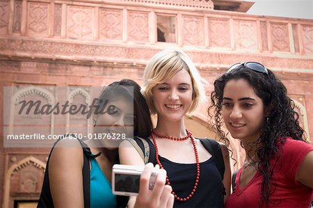 Close-up of three young women taking a picture of themselves, Taj Mahal, Agra, Uttar Pradesh, India