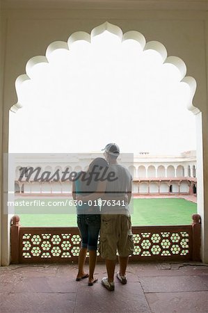 Rear view of a young couple standing with their arms around each other, Taj Mahal, Agra, Uttar Pradesh, India