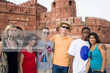 Portrait of a group of friends standing in front of a mausoleum, Taj Mahal, Agra, Uttar Pradesh, India