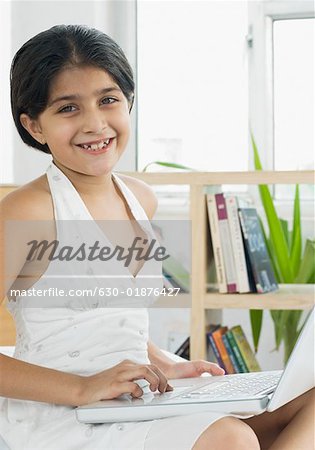 Portrait of a girl using a laptop and smiling