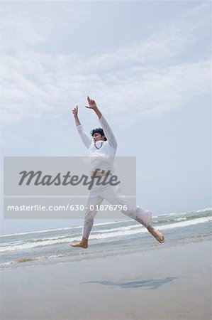 Young man exercising on the beach