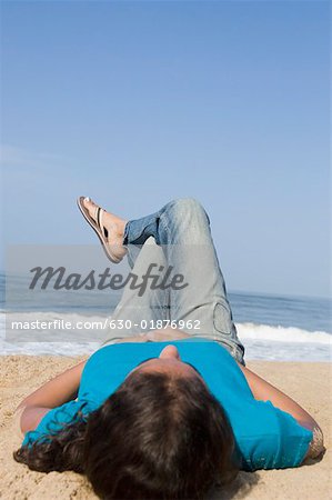 Young woman lying on the beach