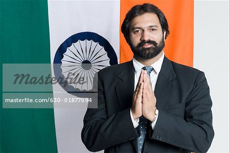 Portrait of a businessman standing in front of an Indian flag