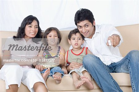Couple sitting with their children on a couch