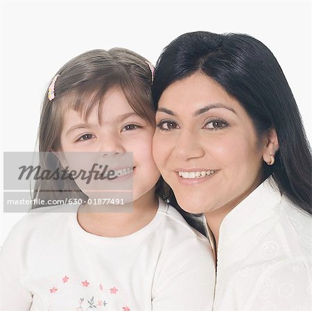 Portrait of a mid adult woman with her daughter smiling