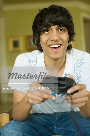 Close-up of a teenage boy playing a video game