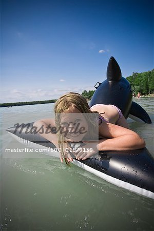 Girl in Water with Inflatable Whale