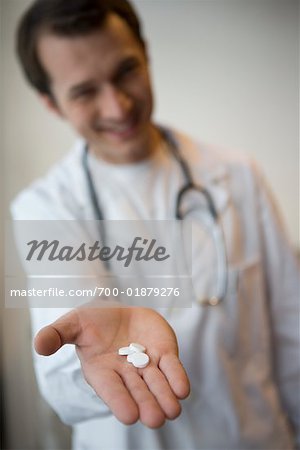 Doctor Holding Pills