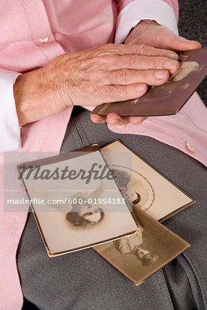 Woman Holding Old Photographs