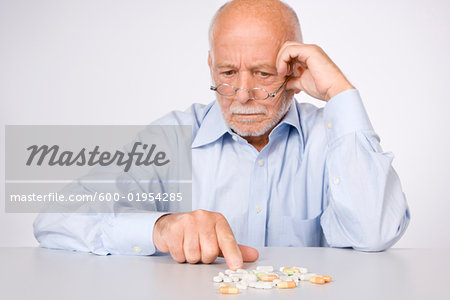 Man Looking at Pills Man Looking at Pills