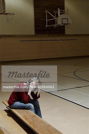 Student in Gymnasium, Talking on Cell Phone